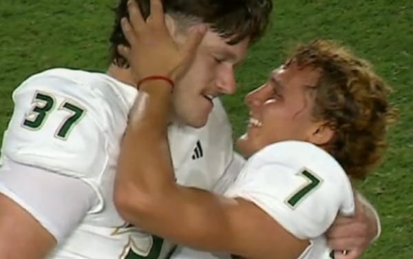 College football players go viral with passionate embrace