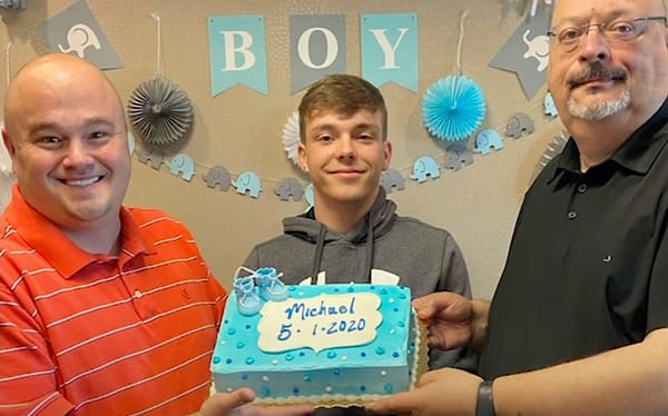 Gay dads adopt teenager over Zoom after he spent five years in foster care