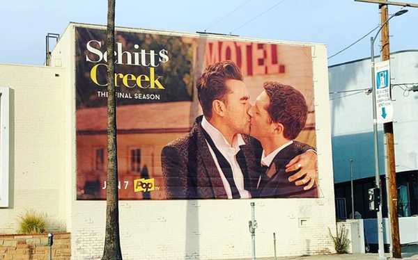 Schitt’s Creek advertises final season with same-sex kiss on billboard